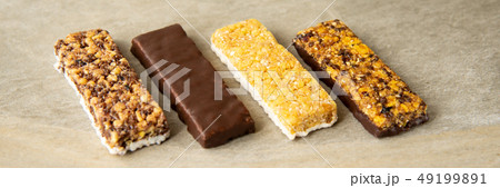 Various muesli bars on marble stone background Various muesli bars on marble stone background 49199891