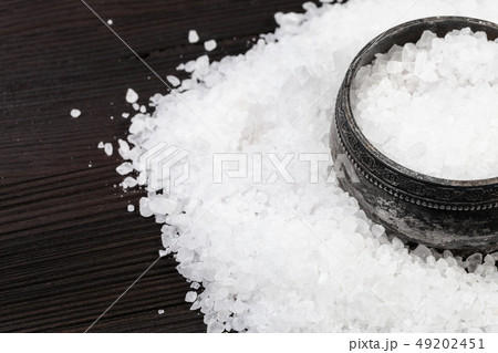 silver salt cellar with coarse Sea Salt on table silver salt cellar with coarse Sea Salt on table 49202451