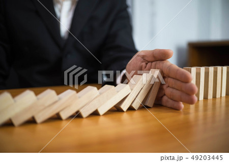 Businessman hand stops domino continuous 49203445