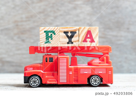 Red fire truck hold letter block in word FYA 49203806