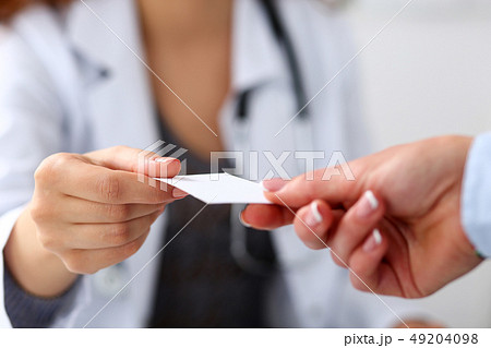 Female physician hand give white blank calling card 49204098