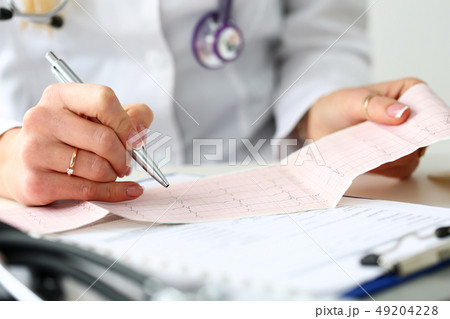 Doctor hands with cardiogram chart on clipboard pad 49204228