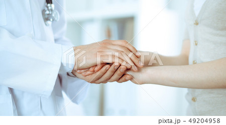Hand of doctor reassuring her female patient. Medicine and health care concept Hand of doctor reassuring her female patient. Medicine and health care concept 49204958