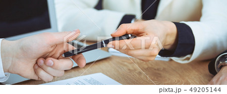Business woman giving pen to businessman ready to sign contract. Success communication at meeting or 49205144
