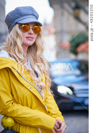 Blonde girl in a yellow raincoat Blonde girl in a yellow raincoat 49205350