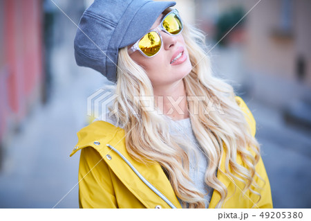 Blonde girl in a yellow raincoat Blonde girl in a yellow raincoat 49205380