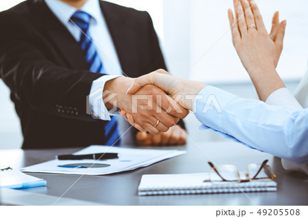 Business people shaking hands, finishing up a meeting 49205508