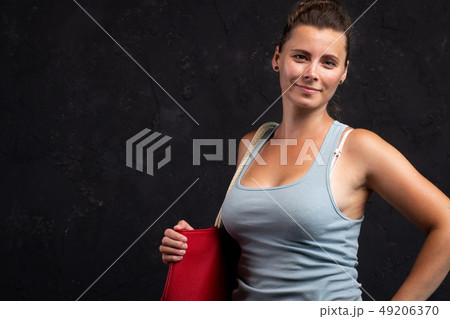 Young woman with bag posing in studio 49206370
