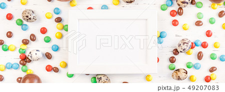 Easter frame with chocolate eggs, colorful candies Easter frame with chocolate eggs, colorful candies 49207083