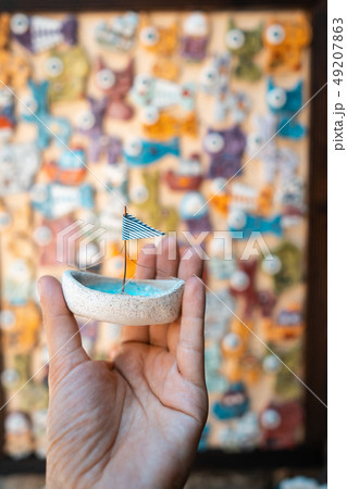 Man's hand holds a toy sailboat with a blue flag Man's hand holds a toy sailboat with a blue flag 49207863