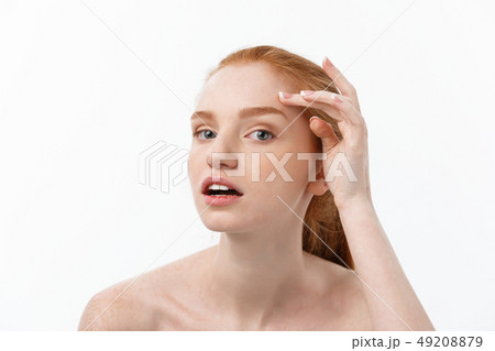 redheaded woman shows fingers on acne on her face. redheaded woman shows fingers on acne on her face. 49208879