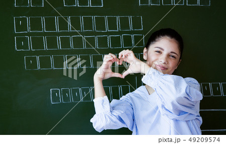 Smiling attractive young girl standing in the Smiling attractive young girl standing in the 49209574