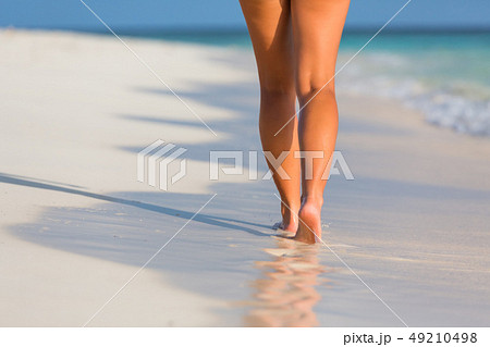 Woman legs walking on the beach 49210498