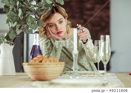 Wife burning the candle while feeling sad staying alone 49211606