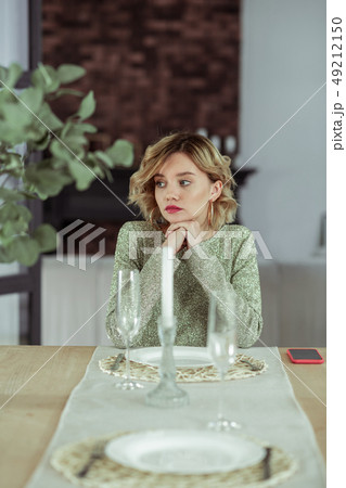 Appealing young girlfriend feeling heartbroken sitting alone 49212150