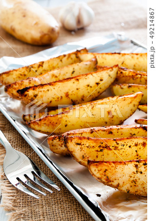 Baked potato wedges on tray - homemade organic 49214867