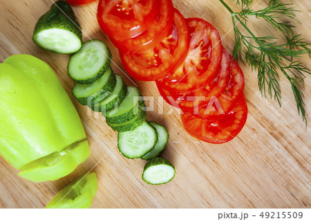 Sliced vegetables for salad on a cutting board. Sliced vegetables for salad on a cutting board. 49215509
