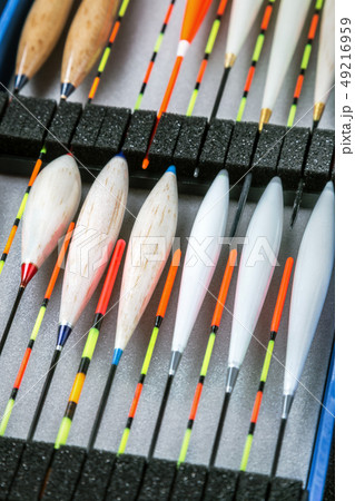 many different fishing floats in the box 49216959