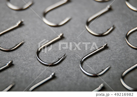 lots of fishing hooks on black background lots of fishing hooks on black background 49216982