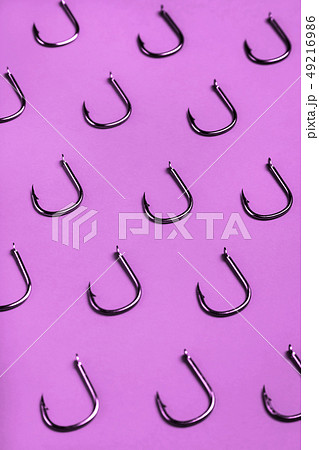lots of fishing hooks on purple background 49216986