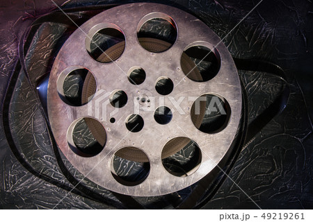 35 mm film reel with dramatic lighting on a dark 49219261