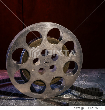 35 mm film reel with dramatic lighting on a dark 35 mm film reel with dramatic lighting on a dark 49219262