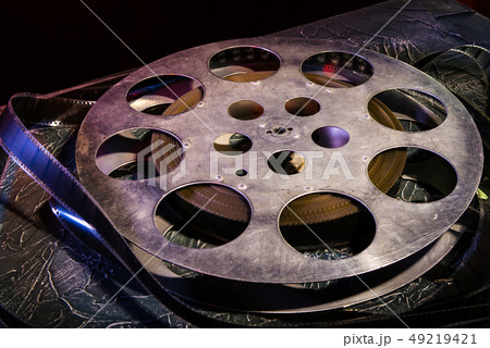 35 mm film reel with dramatic lighting on a dark 35 mm film reel with dramatic lighting on a dark 49219421