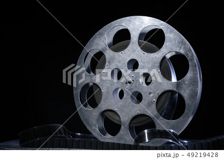 35 mm film reel with dramatic lighting on a dark 35 mm film reel with dramatic lighting on a dark 49219428
