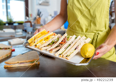 Woman's hand carrying sandwich in tray Woman's hand carrying sandwich in tray 49221239
