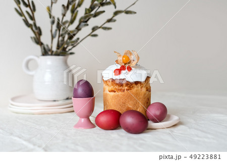 Easter cake and painted eggs. Easter composition with orthodox sweet bread, kulich and eggs on light 49223881