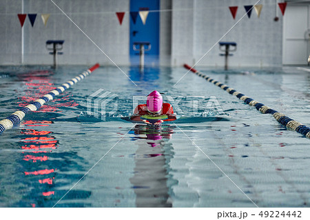 Female athlete in a red-yellow swimsuit is 49224442