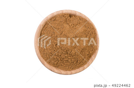 milled or ground nutmeg in wooden bowl isolated on 49224462