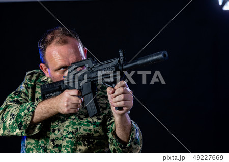 Soldier holding assault rifle 49227669