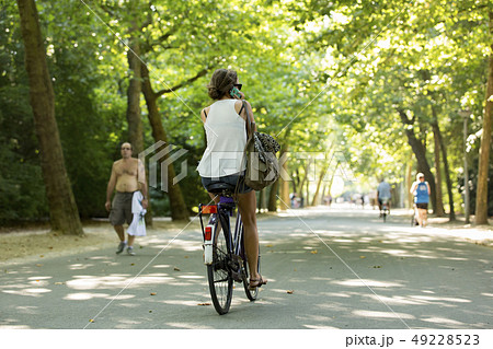 Girl biking & calling in the Amsterdam Vondelpark. 49228523