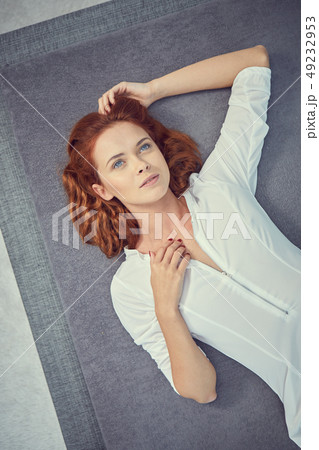redhead girl is lying on the bed redhead girl is lying on the bed 49232953