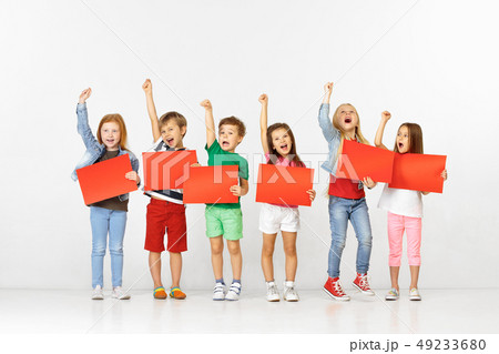 Group of children with red banners isolated in white 49233680