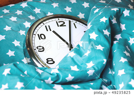 Big wall clock in a blue bed 49235825