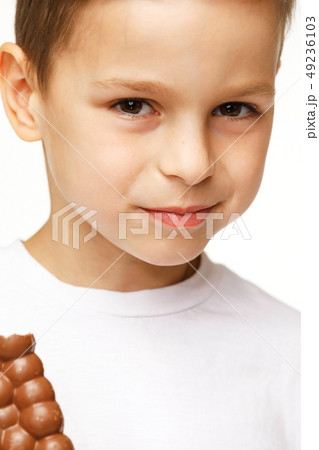 little beautiful boy eating chocolate studio shot little beautiful boy eating chocolate studio shot 49236103