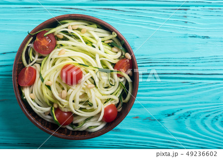 Zucchini pasta noodles with tomatoes . Healthy 49236602