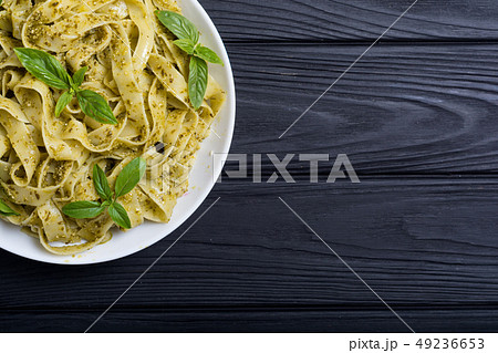 Pasta tagliatelle with green sauce pesto . Italian 49236653