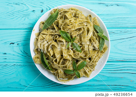 Pasta tagliatelle with green sauce pesto . Italian Pasta tagliatelle with green sauce pesto . Italian 49236654