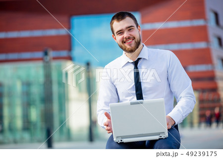 Young businesman with laptop computer 49239175