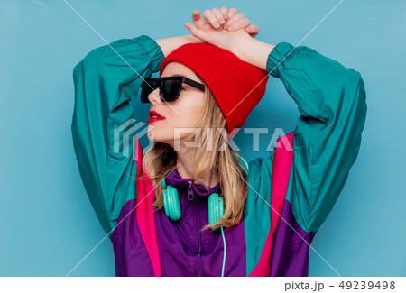 woman in red hat, sunglasses and suit of 90s with headphones 49239498