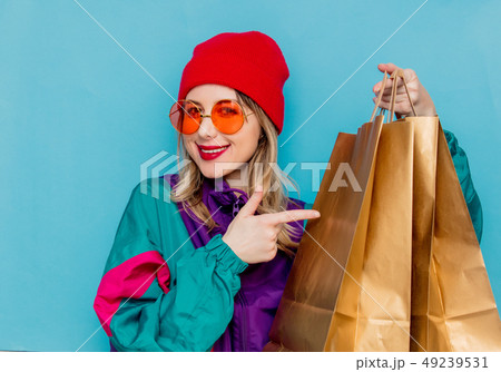 woman in suit of 90s with shopping bags woman in suit of 90s with shopping bags 49239531