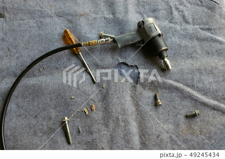 Drill with drill bits, screws on dark Drill with drill bits, screws on dark 49245434