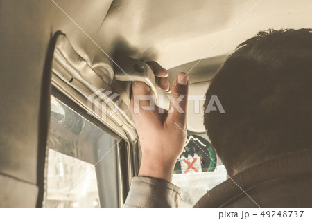Man Hand on handle sit front passenger of a car Man Hand on handle sit front passenger of a car 49248737