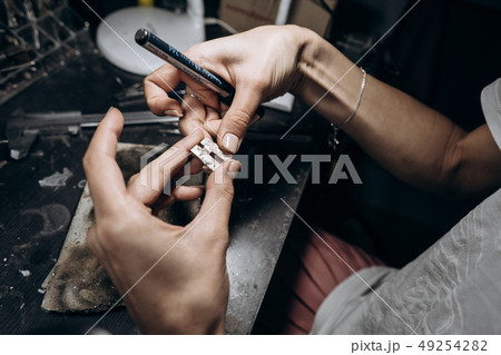 The master jeweler applies markup to the jewelry 49254282