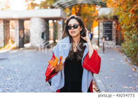 Fashion portrait of beautiful woman in autumn park Fashion portrait of beautiful woman in autumn park 49254773