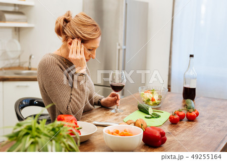 Sad mature woman being alone at home and drinking red wine 49255164