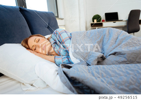 Peaceful middle-aged woman sleeping in her bed alone 49256515